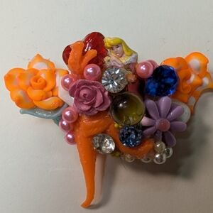 Wendy Gell pop art pin Cinderella Tyrannosaurus Rex with jewels and flowers.